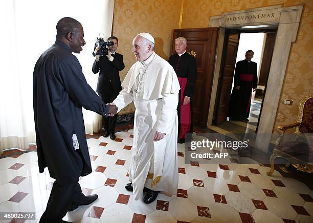Pope Francis meets Nigerian President Goodluck Jonathan as he arrives for a private audience at the Vatican on March 22, 2014. AFP PHOTO POOL / TONY...
