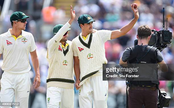 Australia bowler Mitchell Starc celebrates his five wicket haul with Nathan Lyon during day two of the 1st Investec Ashes Test match between England...