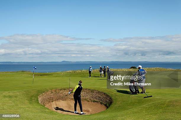 Ian Poulter of England hits a shot from a greenside bunker on the eighth hole during the first round of the Aberdeen Asset Management Scottish Open...