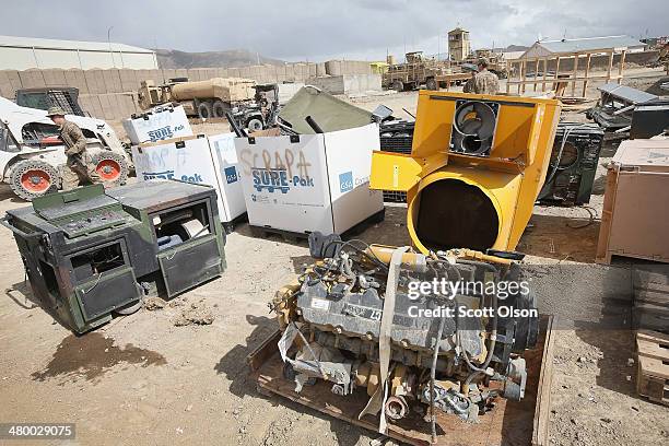 Damaged, destroyed and redundant equipment and supplies left by departing units as the U.S. Draws down manpower in the 13-year-old war sit in a...