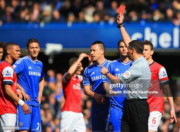 Referee Andre Marriner shows Kieran Gibbs of Arsenal a red card during the Barclays Premier League match between Chelsea and Arsenal at Stamford...