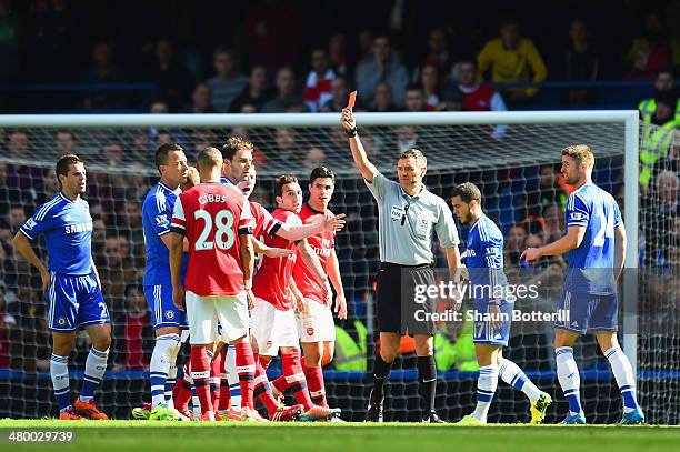 Referee Andre Marriner shows Kieran Gibbs of Arsenal a red card during the Barclays Premier League match between Chelsea and Arsenal at Stamford...