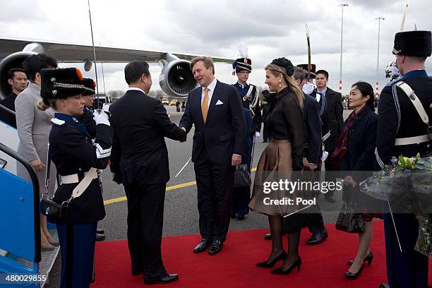 China's President Xi Jinping, center left, and his wife Peng Liyuan, far left, are greeted by King Willem-Alexander of the Netherlands, center, and...