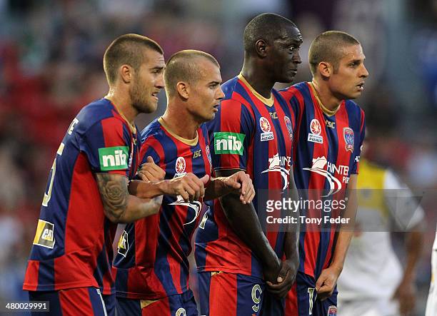 Jets teammates Josh Brillante, Joel Griffiths, Emile Heskey and Josh Mitchell watch a free kick during the round 24 A-League match between the...