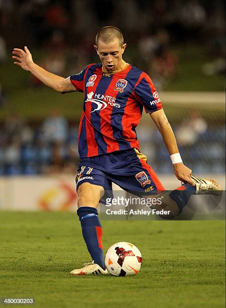 Craig Goodwin of the Jets controls the ball ahead of the Phoenix defence during the round 24 A-League match between the Newcastle Jets and Wellington...
