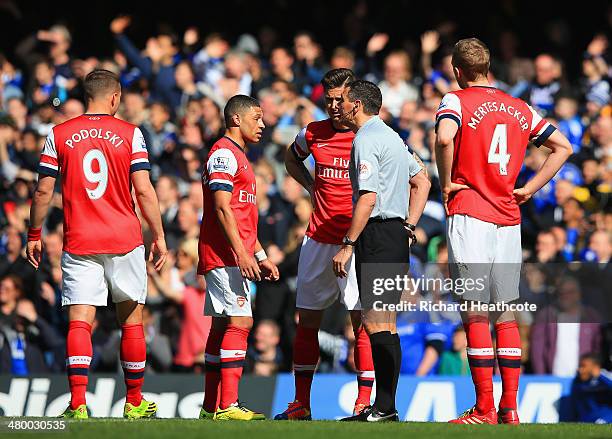 Alex Oxlade-Chamberlain of Arsenal appeals to Referee Andre Marriner after he gave Kieran Gibbs of Arsenal a red card during the Barclays Premier...