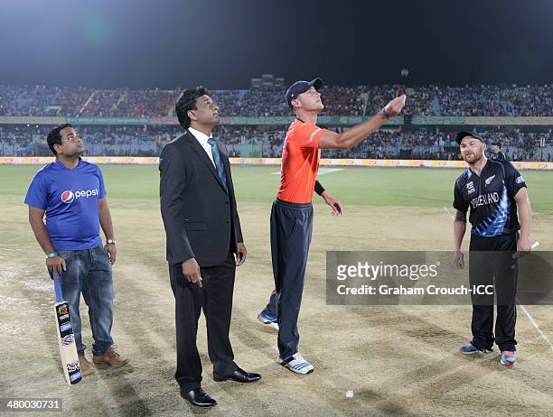 Stuart Broad, captain of England tosses the coin with Brendon McCullum, captain of New Zealand, match referee Javagal Srinath and Pepsi mascot Rayhan...
