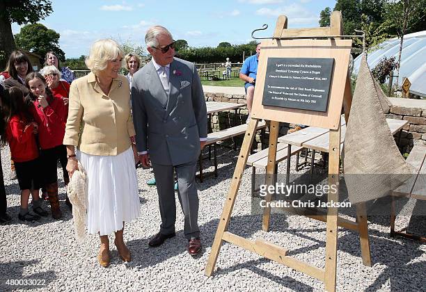 Prince Charles, Prince of Wales and Camilla, Duchess of Cornwall unveil a plaque as they visit Humble by Nature Farm on July 9 2015 in Monmouth,...