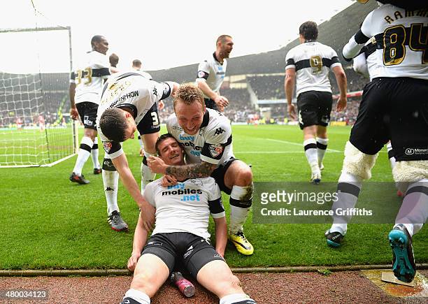 Craig Bryson of Derby County is mobbed after scoring his third goal from the penalty spot during the Sky Bet Championship match between Derby County...