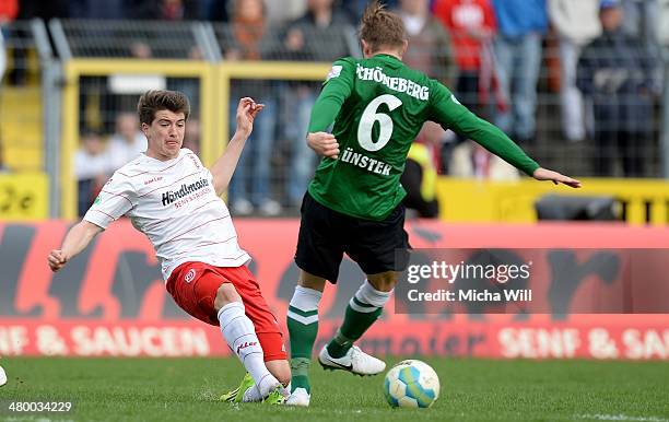 Jim-Patrick Mueller of Regensburg challenges Kevin Schoeneberg of Muenster during the Third League match between Jahn Regensburg and Preussen...
