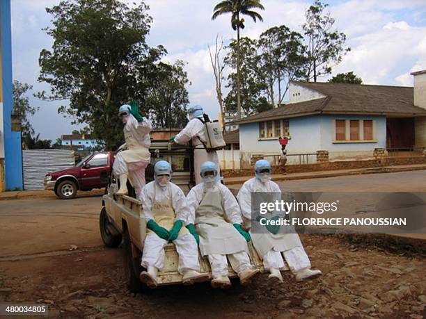 Five health workers, dressed in head-to-toe "Ebola suits" leave in a pick-up truck 09 April 2005 in Uige, about 300km north of the capital, Luanda,...