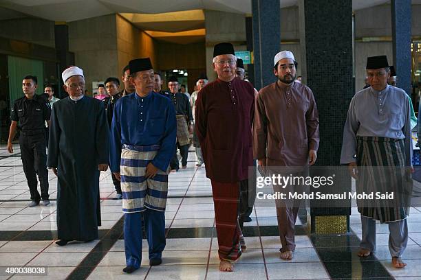 Malaysia Prime Minister Najib Razak wearing a read colour leave after a special events in holy month of ramadan inside the National mosque on July 9,...