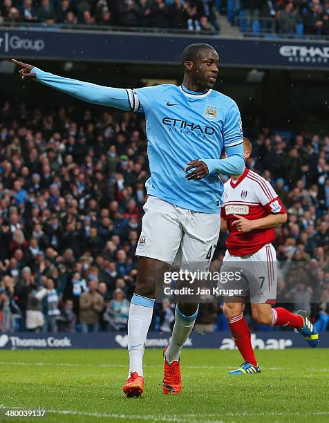 Yaya Toure of Manchester City celebrates scoring the opening goal from the penalty spot during the Barclays Premier League match between Manchester...