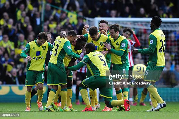 Alex Tettey of Norwich City celebrates scoring their second goal with team-mates during the Barclays Premier League match between Norwich City and...