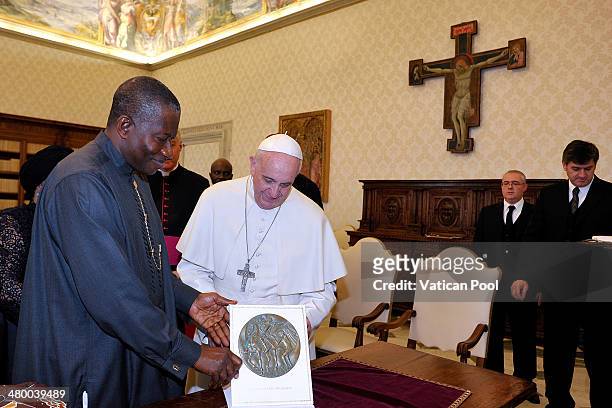 Pope Francis exchanges gifts with President of Nigeria Goodluck Jonathan at his private library in the Apostolic Palace on March 22, 2014 in Vatican...