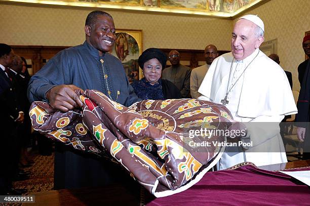 Pope Francis exchanges gifts with President of Nigeria Goodluck Jonathan and his wife Patience Jonathan at his private library in the Apostolic...