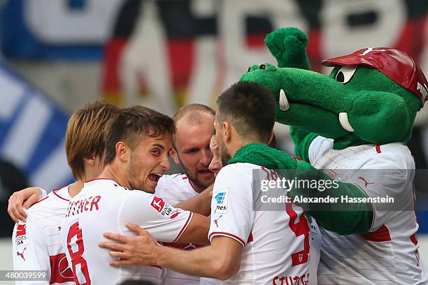 Alexandru Maxim of Stuttgart celebrates scoring the opening goal with his team mates and their mascot Fritzle the opening goal during the Bundesliga...