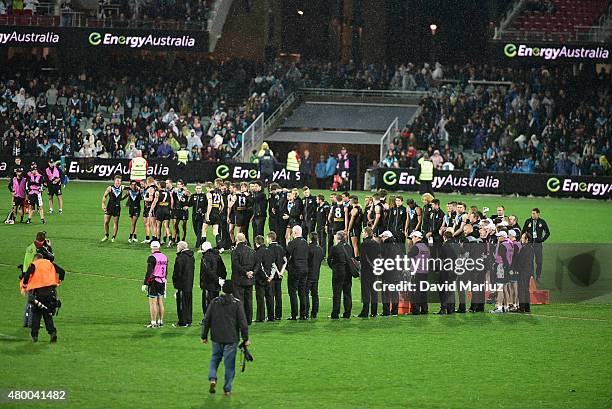 The players form a semi circle on the pitch at the end of the game in respect for Phil Walsh after the round 15 AFL match between Port Adelaide Power...