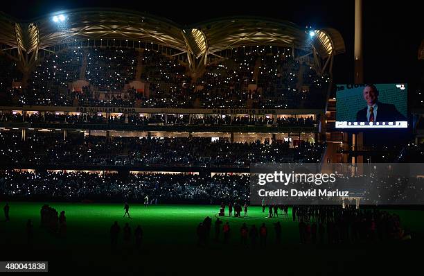 The players form a semi circle on the pitch at the end of the game in respect for Phil Walsh after the round 15 AFL match between Port Adelaide Power...