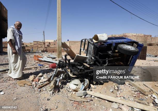 Man from the Arab community walks past the wreckage of a vehicle on July 9 following clashes between Berbers and Arabs in the Algerian town of...