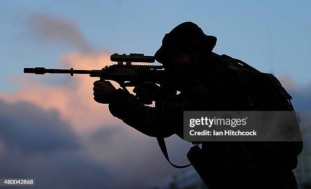 Captain Nick Garrett from Headquarters 7 Brigade looks through the sights of his rifle as part of exercise Talisman Sabre on July 9, 2015 in...