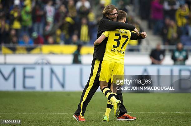 Dortmund's head coach Juergen Klopp celebrates with Dortmund's defender Erik Durm after the German first division Bundesliga football match Hannover...