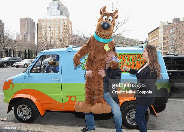 Wrestler Triple H and WWE Chief Brand Officer Stephanie McMahon lift Scooby Doo in the air during the "Scooby Doo! WrestleMania Mystery" New York...