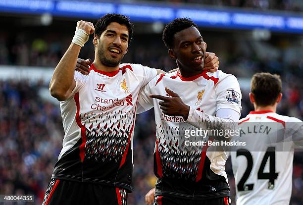 Daniel Sturridge of Liverpool celebrates with team mate Luis Suarez after scoring his team's fifth goal during the Barclays Premier League match...