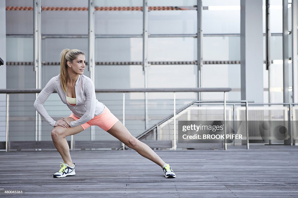 Young woman athlete stretching