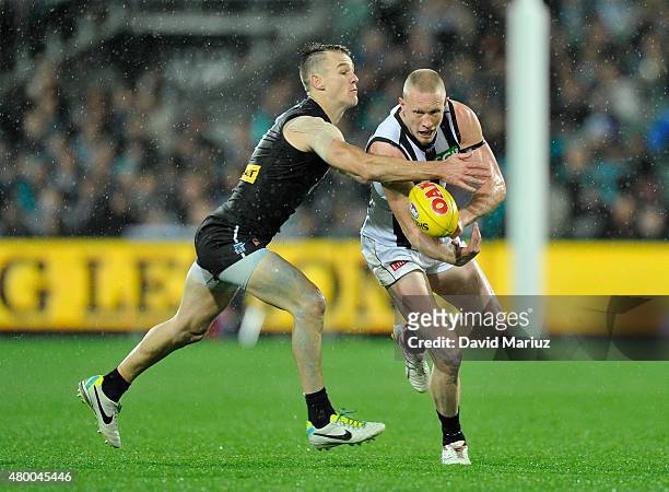 Robbie Gray of the Power and Jack Frost of the Magpies during the round 15 AFL match between Port Adelaide Power and Collingwood Magpies at Adelaide...
