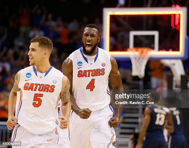 Scottie Wilbekin and Patric Young of the Florida Gators celebrate after Wilbekin makes a three-pointer to end the first half against the Pittsburgh...