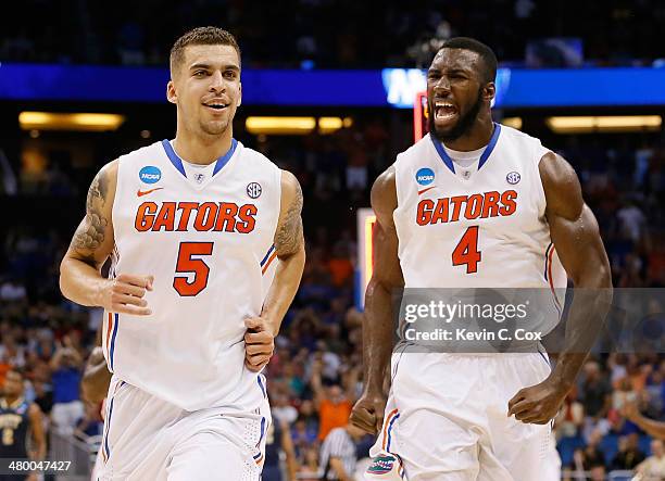 Scottie Wilbekin and Patric Young of the Florida Gators celebrate after Wilbekin makes a three-pointer to end the first half against the Pittsburgh...