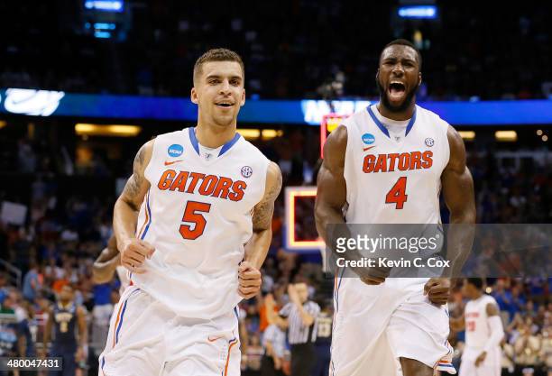Scottie Wilbekin and Patric Young of the Florida Gators celebrate after Wilbekin makes a three-pointer to end the first half against the Pittsburgh...