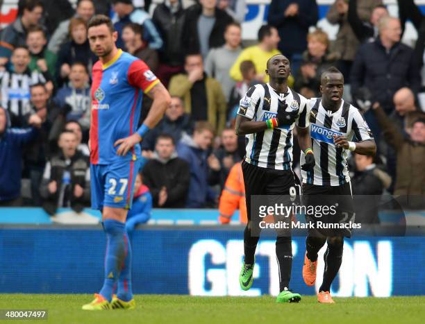Papiss Cisse of Newcastle celebrates his last minute goal with team mate Cheick Tiote during the Barclays Premier League match between Newcastle and...