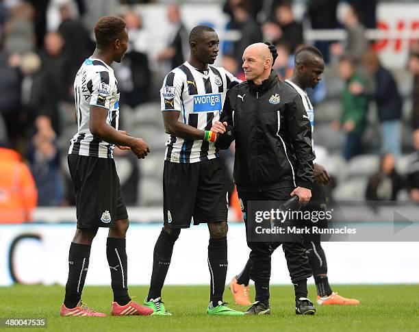 Papiss Cisse of Newcastle is greeted by coach Steve Stone at the end of the Barclays Premier League match between Newcastle and Crystal Palace at St...