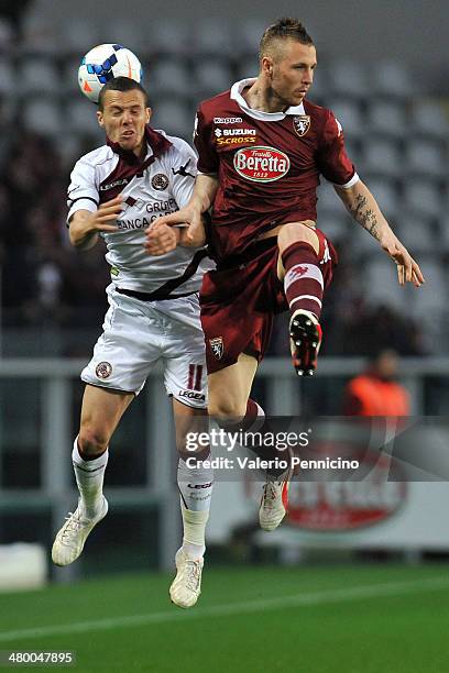 Jasmin Kurtic of Torino FC goes up with Djamel Mesbah of AS Livorno Calcio during the Serie A match between Torino FC and AS Livorno Calcio at Stadio...