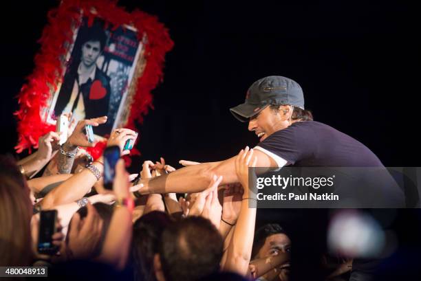 Musician Enrique Iglesias reaches out to fans during a performance at the United Center, Chicago, Illinois, August 4, 2012.