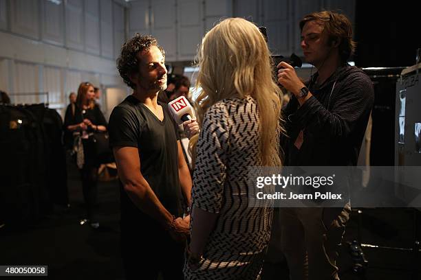 Designer Dimitrios Panagiotopoulos is being interviewed by Mirja du Mont backtstage ahead of the Dimitri show during the Mercedes-Benz Fashion Week...