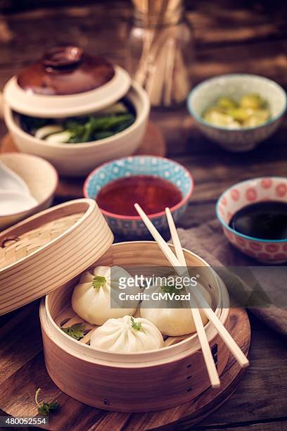 dim sum dumplings freshly steamed in a bamboo steamer - chinese dumpling stock pictures, royalty-free photos & images