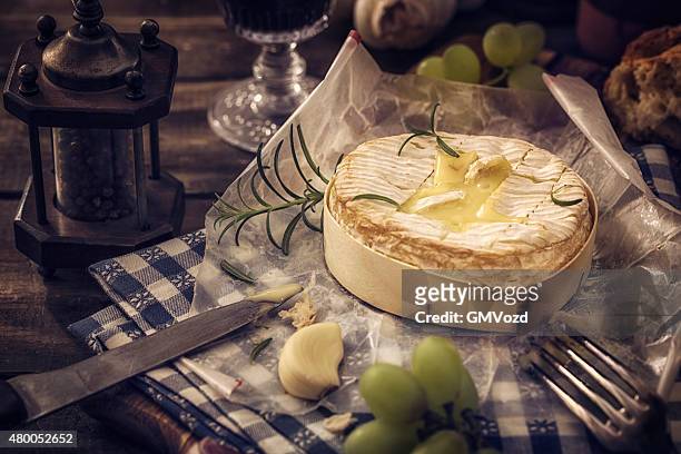 baked camembert cheese with garlic and rosemary - baked brie stock pictures, royalty-free photos & images