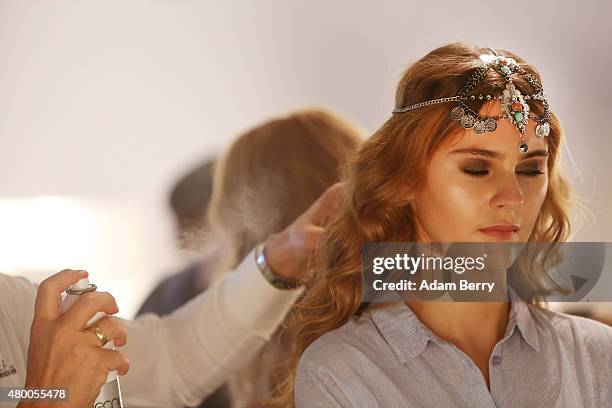 Model prepares backstage at the Dimitri show during the Mercedes-Benz Fashion Week Berlin Spring/Summer 2016 at Brandenburg Gate on July 9, 2015 in...