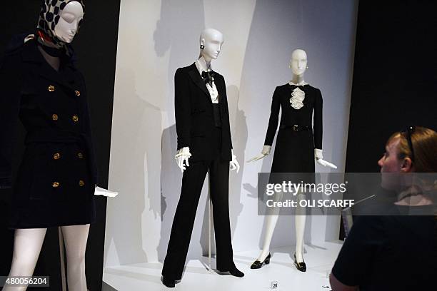 Woman views the first tuxedo designed by French fashion designer Yves Saint Laurent during a photocall at the Bowes Museum in Barnard Castle, in...