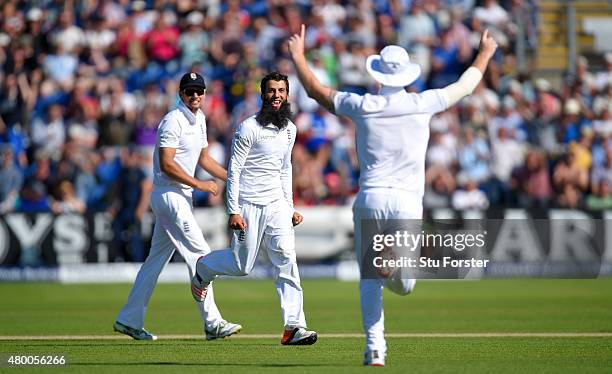 England bowler Moeen Ali celebrates with Alastair Cook and Ben Stokes after dismissing Michael Clarke during day two of the 1st Investec Ashes Test...