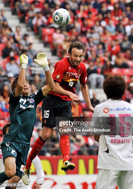 Joshua Kennedy of Nagoya Grampus and Kim Jin-hyeon of Cerezo Osaka compete for the ball during the J.League match between Nagoya Grampus and Cerezo...