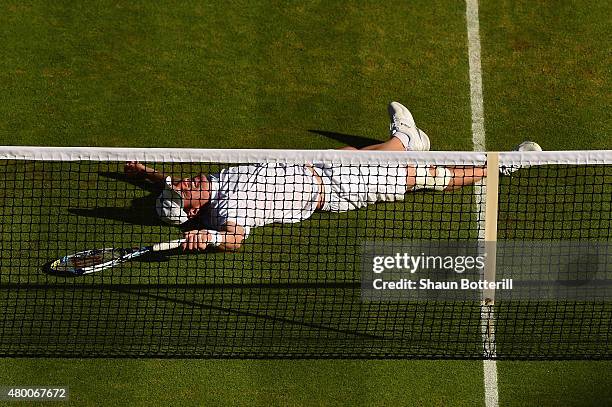 Jonathan Erlich of Israel falls at the net playing with partner Philipp Petzschner of Germany in the Gentlemens Doubles Semi Final match against John...