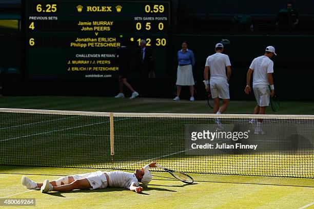 Jonathan Erlich of Israel lies at the net playing with partner Philipp Petzschner of Germany in the Gentlemens Doubles Semi Final match against John...