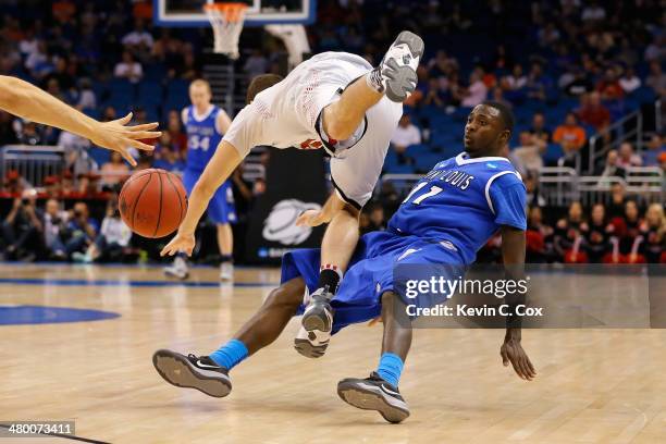 Luke Hancock of the Louisville Cardinals is called for traveling against Mike McCall Jr. #11 of the Saint Louis Billikens in the second half during...