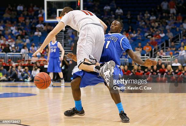 Luke Hancock of the Louisville Cardinals is called for traveling against Mike McCall Jr. #11 of the Saint Louis Billikens in the second half during...