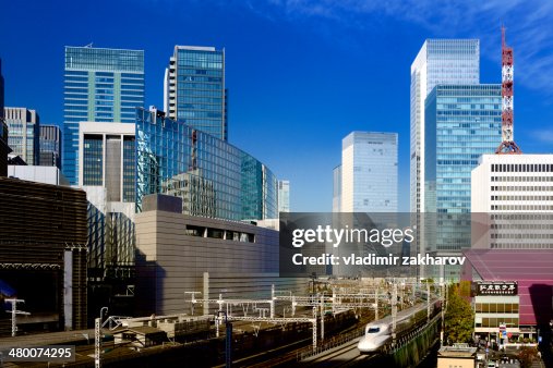 Skyscrapers of Marunouchi and passing train Skyscrapers of Marunouchi and passing train