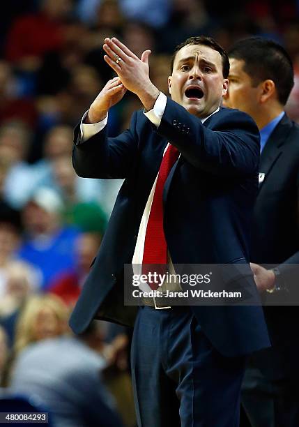 Head coach Archie Miller of the Dayton Flyers signals for a timeout against the Syracuse Orange during the third round of the 2014 NCAA Men's...